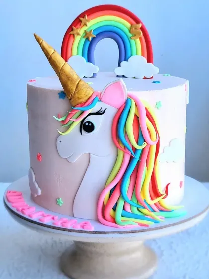 A magical unicorn cake with a vibrant rainbow mane and a golden horn. This class favorite covers how to create a smooth fondant unicorn face and pipe a colorful, flowing mane.