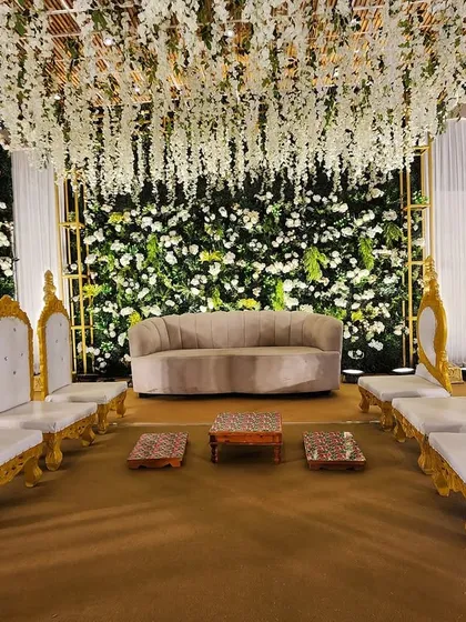 The family seating arrangement on the elegant green floral stage, providing a beautiful and comfortable space for the closest family members.