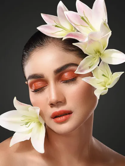 Another shot from the "Bloom" series, this portrait uses soft lilies and warm makeup tones to create a peaceful, ethereal mood. It shows my ability to create different feelings within a single creative concept, from bold to serene.