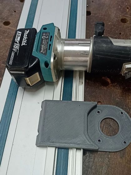 This is a 3D-printed baseplate I designed to adapt my Makita cordless router for use with a guide rail. It's a great example of how modern tech can enhance traditional woodworking.