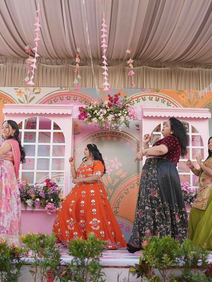 The bride and her friends enjoying a dance performance on the Mehandi stage. I ensure the stage is not just beautiful but also spacious enough for all the fun and festivities.