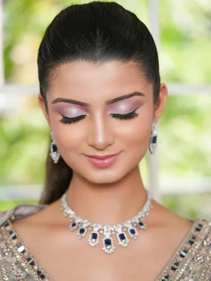 A close-up beauty shot showing the eye makeup and the sparkle of the rental jewellery.