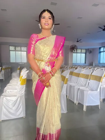 The full look, showcasing the elegant saree and the timeless makeup in the event hall setting.