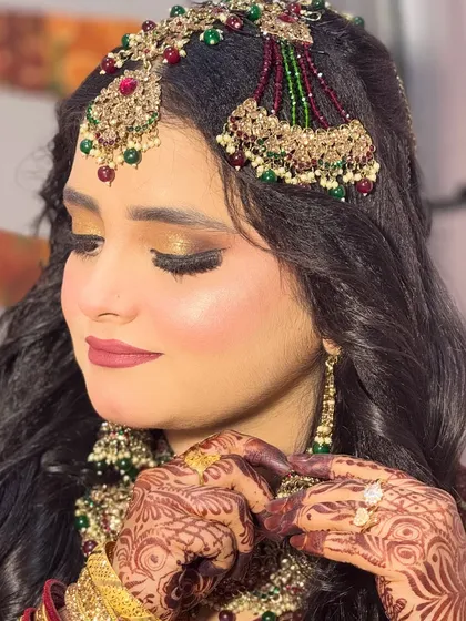 A close-up of the Walima bride's eye makeup. The golden glitter is packed onto the lid for maximum impact, while the crease is softly defined to add dimension.