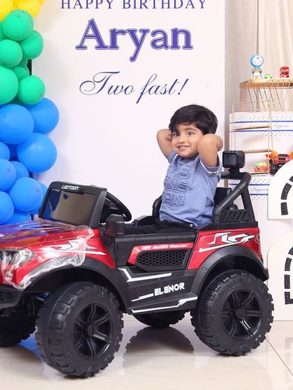 A thrilling 'PJ Masks' themed birthday party, with character cutouts, a cityscape backdrop, and blue and green balloons, ready for a night of adventure.