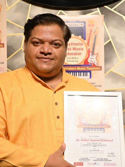 Mr. Vishal Jaywant Gaikwad with his "Rhythmite Best Music Educator" award for Tabla. His dedication to teaching has helped many students find their rhythm.