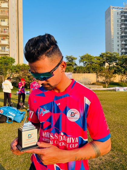 "Be a Game Changer. The world is already full of players." Holding the trophy after a successful match.