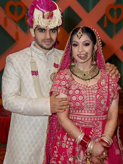 A formal wedding portrait of the couple. This shot captures the groom's arm around his bride, showing a sense of love and protection on their big day.