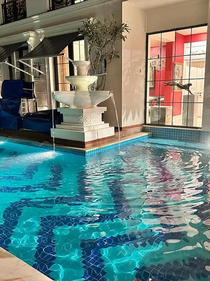 We go beyond standard pool construction by integrating unique water features and lighting. This project features a custom-tiled pool with a tiered stone fountain, creating a resort-like feel right in your backyard.