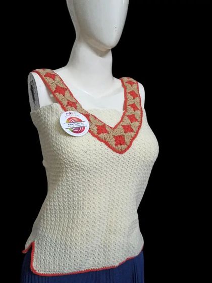 This V-neck sleeveless top has a beautiful patterned border in red and beige. The main body is made with a dense stitch, providing good coverage while still feeling handmade.