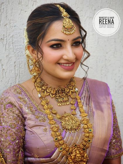 Another beautiful portrait of Nidhi. Her soft, wavy hair framing her face adds a touch of modern romance to her traditional South Indian bridal look.