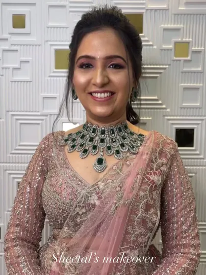 This engagement bride looks absolutely radiant. Her stunning green and silver necklace is the centerpiece, complemented by soft pink makeup and an elegant updo.