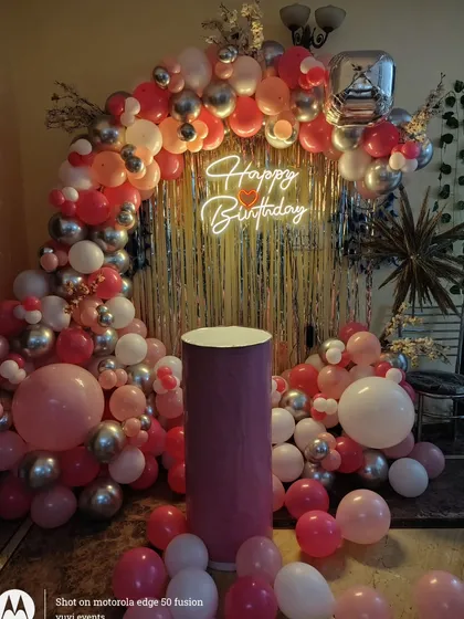 A different lighting angle on the pink and silver birthday setup.