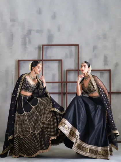 For an evening reception or cocktail party, a black lehenga offers a dramatic and sophisticated alternative. These two embellished designs play with gold embroidery on black fabric, creating a rich, powerful look that is undeniably glamorous.