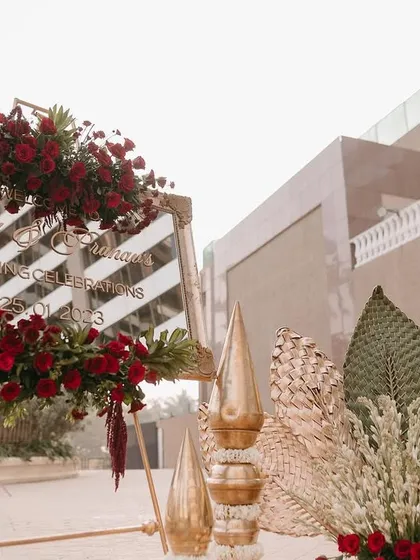 The welcome setup, combining the mirror sign with traditional brass decor and floral elements.
