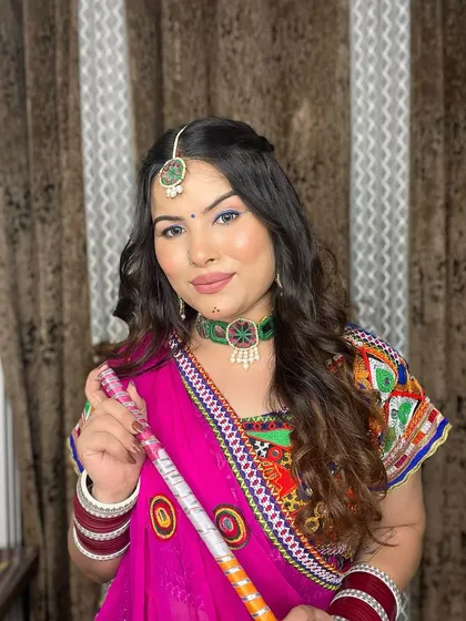 A festive look for Navratri, ready for a night of dandiya. The makeup features a pop of blue eyeliner and a traditional bindi.
