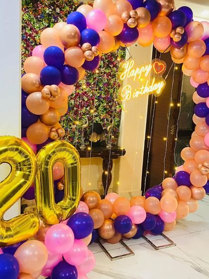 A close-up of the 20th birthday setup, showing the mix of balloon colors and the large number balloons.