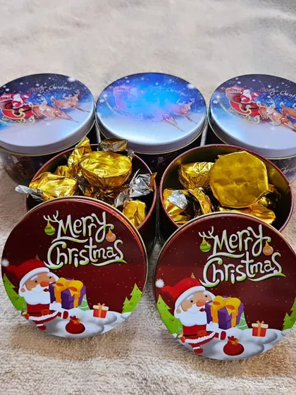 The Christmas tins opened to show they are filled with my assorted handmade chocolates.