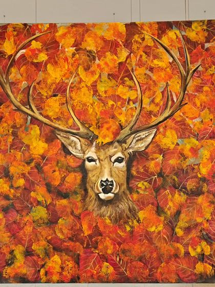 A popular creation by artist Malika Vijay from 'Nature's Symphony', showing a deer surrounded by vibrant autumn leaves.