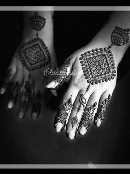 A bold, modern design in black and white. The back of the hand features a large square filled with intricate patterns, with a smaller motif on the wrist, creating a striking geometric look.