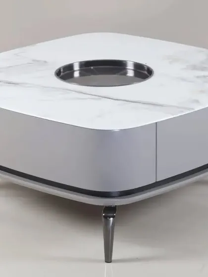 A luxury coffee table with a white marble top and a central built-in tray. The sleek grey base and tapered legs add to its modern appeal.