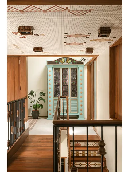 This custom bar cabinet was designed as a centerpiece for a landing. Inspired by Chettinad architecture, it features stained glass panels and a playful colour palette of mint green and ochre, making it a joyful and nostalgic statement piece.