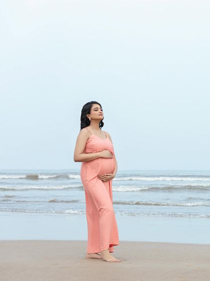 Soaking in the peaceful beach atmosphere. This full-length portrait captures the serenity of the moment and the beauty of the natural surroundings.