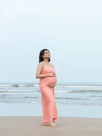 Soaking in the peaceful beach atmosphere. This full-length portrait captures the serenity of the moment and the beauty of the natural surroundings.