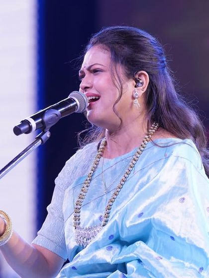 An emotional moment during the concert, where the elegant styling supports the artist's performance.