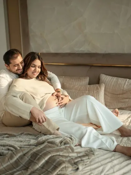 Another beautiful moment from a lifestyle maternity session. The soft natural light and comfortable setting on the bed create a feeling of peace and domestic bliss.