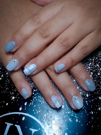A chic and cozy design in a soft grey, featuring a mix of glitter, plaid pattern, and rhinestone accents.