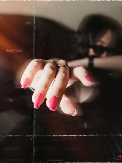 A close-up on the details, like my pink nails, adding a pop of color to the monochrome look.