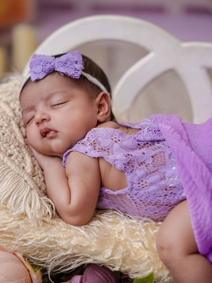 A sleeping angel in lavender. The delicate lace outfit and soft purple tones make this a truly dreamy and romantic portrait.