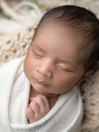Deep in dreamland. This close-up captures the serene expression of a sleeping newborn, a moment of pure peace.