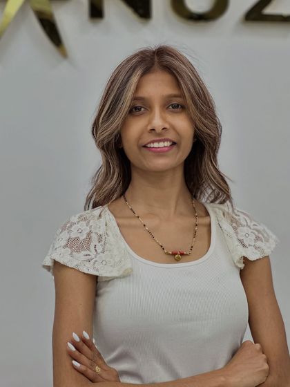 The client's happy smile says everything about her new beige blonde and layered look.