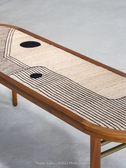 Further details of the Ela Accent Table, showing the texture of the banana fiber top and the sleek combination of wood and brass. This piece is designed as art furniture, a unique statement for any space.