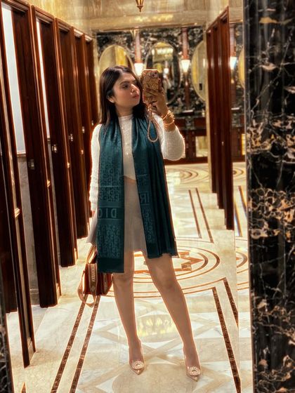 A mirror selfie showing the full length of the sophisticated winter look.