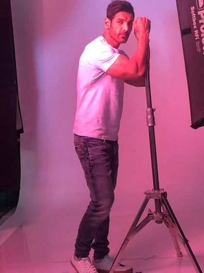 A candid moment with John Abraham during a studio photoshoot. My job often involves being on hand to make sure everything looks perfect for the camera.