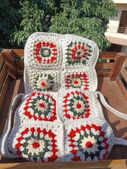 Showing the front and back of the granny square bag. The pattern is consistent on both sides, showcasing the quality of the craftsmanship.