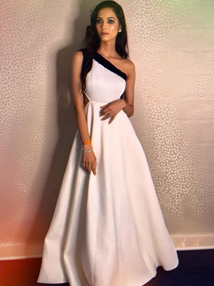 Simple, modern, and chic. This white scuba gown with a contrasting black one-shoulder detail is perfect for a minimalist who still wants to make a statement at a party.