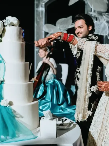 The cake cutting ceremony is a classic reception moment. I ensure it is beautifully staged, with elements like this stunning five-tier cake and live musicians creating a perfect photo opportunity.