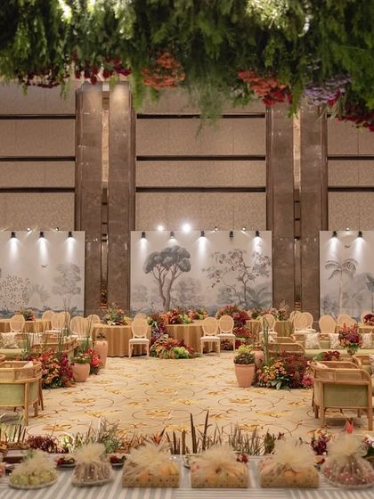 A wide view of the 'Orchard of Life' hall, with seating arranged around the central floral trees.