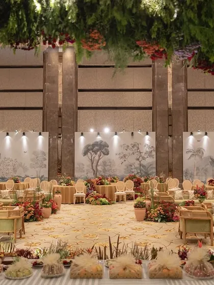 A wide view of the 'Orchard of Life' hall, with seating arranged around the central floral trees.