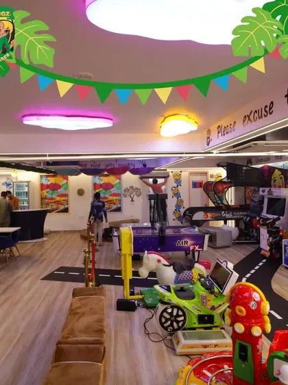 A wide view of our vibrant space, showing the arcade and gaming lounge that flows into the cafe area. I've designed it to be an open, engaging environment where fun is around every corner.