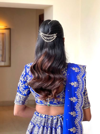 The back view of the half updo, showing the placement of the accessory and the flow of the waves.
