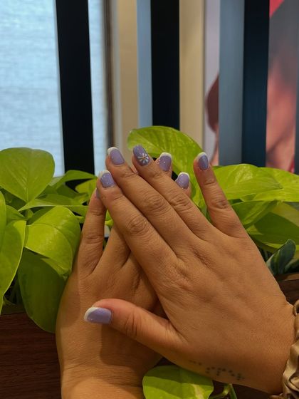The subtle white tips on this lavender set give it a modern French manicure feel. It’s a fresh twist on two classic styles.