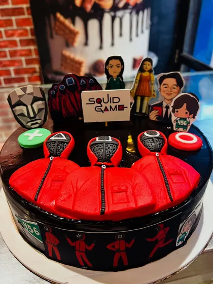 A full view of the dark and mysterious Squid Game cake, perfect for a fan's birthday party.