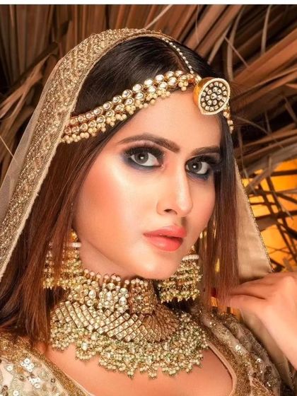 A royal Pachi Kundan bridal set in a champagne gold tone. The oversized earrings and heavy choker are perfect for making a grand entrance.