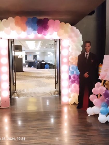 The full view of the lit entrance arch, creating a grand welcome for guests.