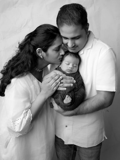 The mother's gentle kiss is a moment of pure love, made even more poignant and timeless in black and white.